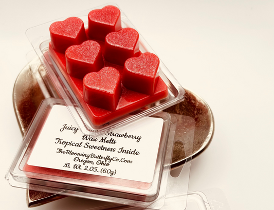 Juicy strawberry guava heart shaped wax melts with shimmering, red and silver glitter color in heart shaped clam shells by the blooming butterfly Company