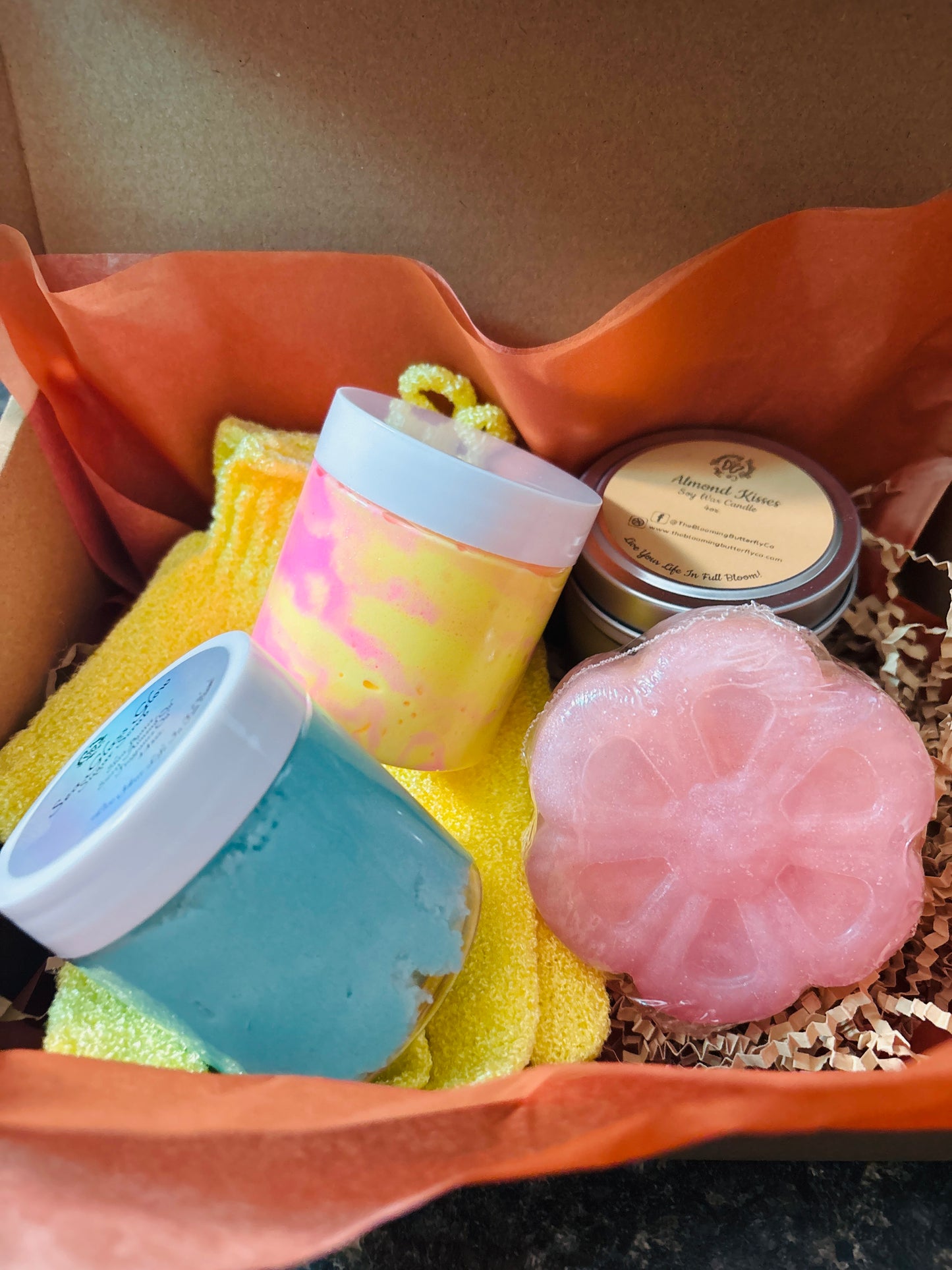 Creamy sugar scrub, whipped body butter, soy wax candle, bold fragrances, loofah soap bar in a bundle with exfoliating bath gloves