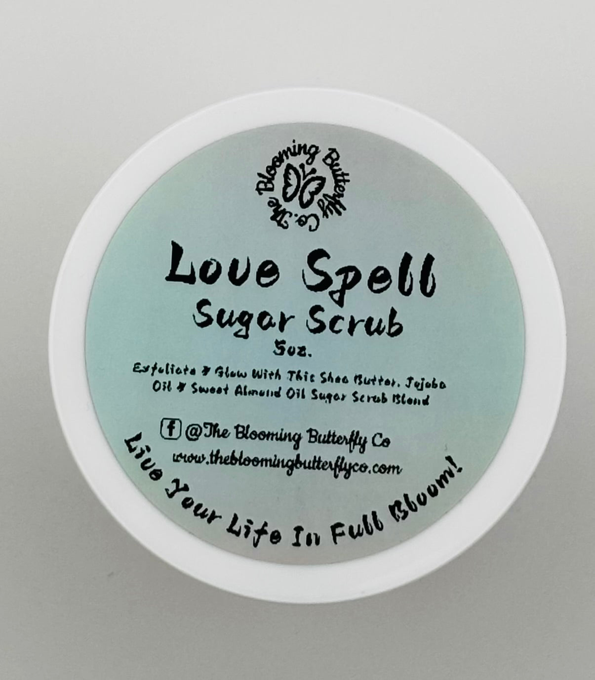 love spell sugar scrub lid with ingredients and branding