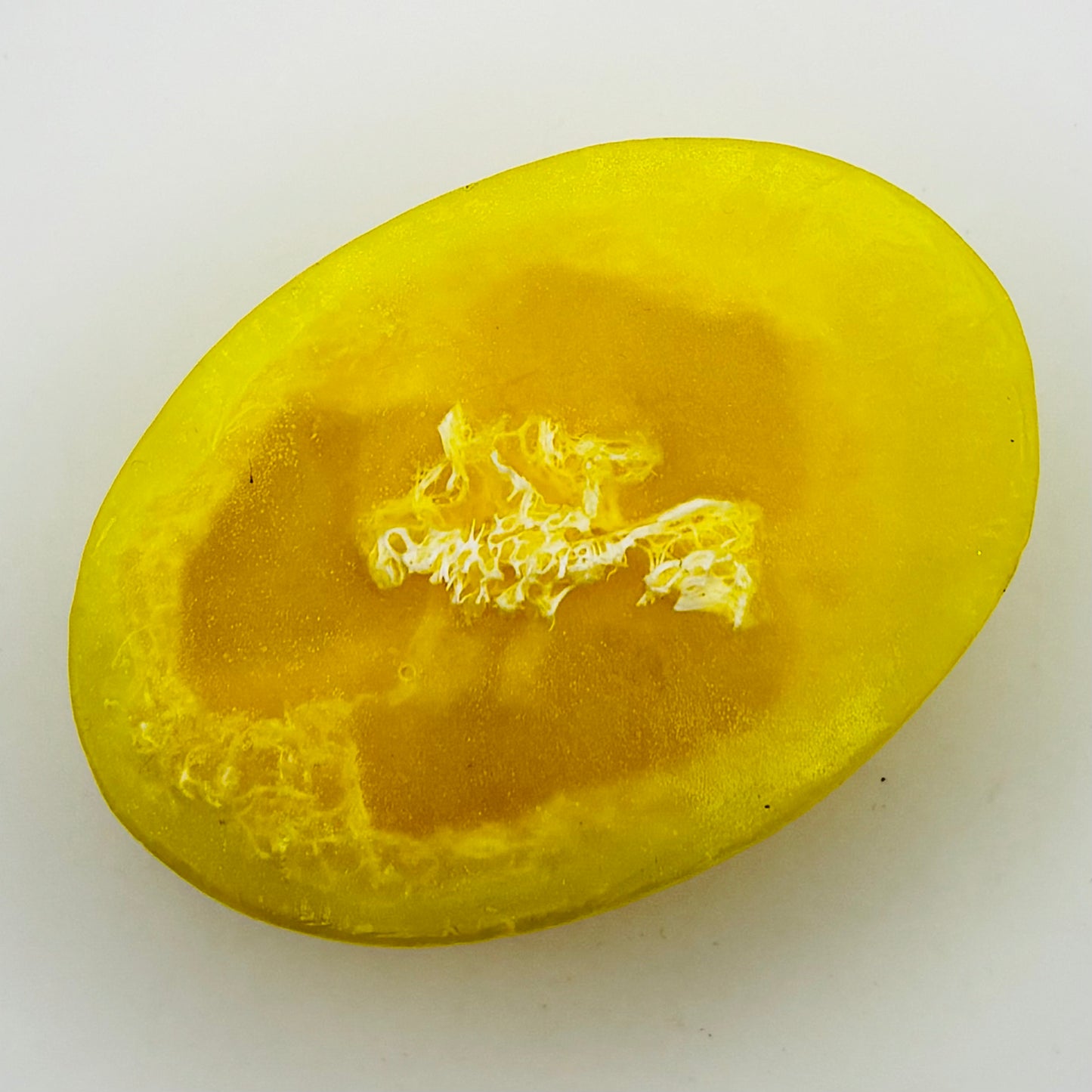 close up top view of bright yellow citrus agave loofah soap bar by the blooming butterfly company