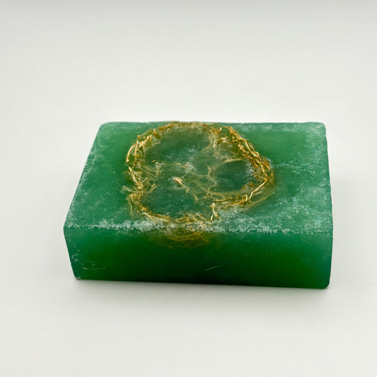 close up, top view of a rectangular shimmering green loofah soap bar by the blooming butterfly company