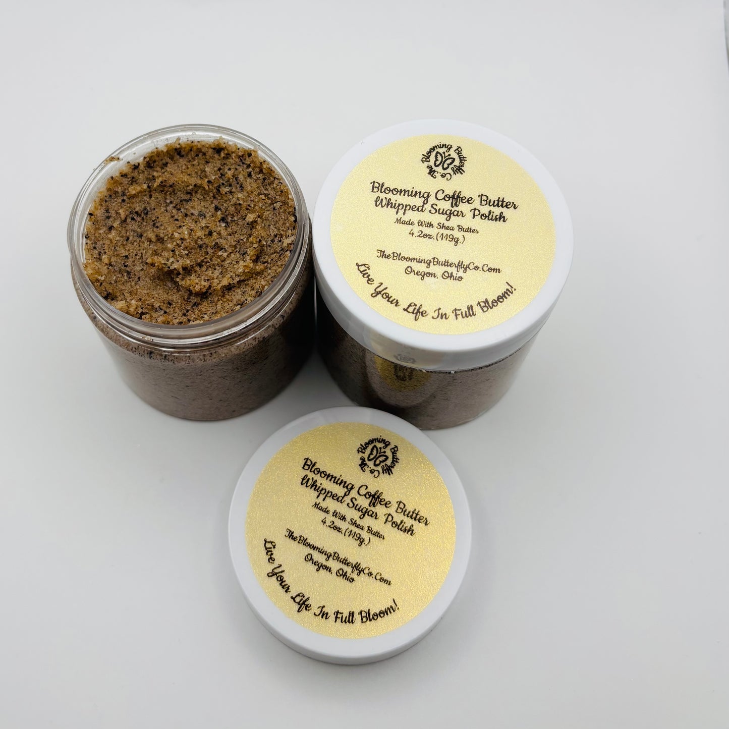 Two containers of Blooming Coffee Butter Whipped Sugar Polish on a white background handcrafted by the blooming butterfly company