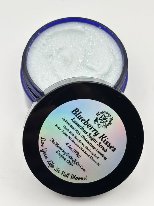 Blueberry Kisses luxurious sugar scrub in open jar with lid on a white background handcrafted by the blooming butterfly company