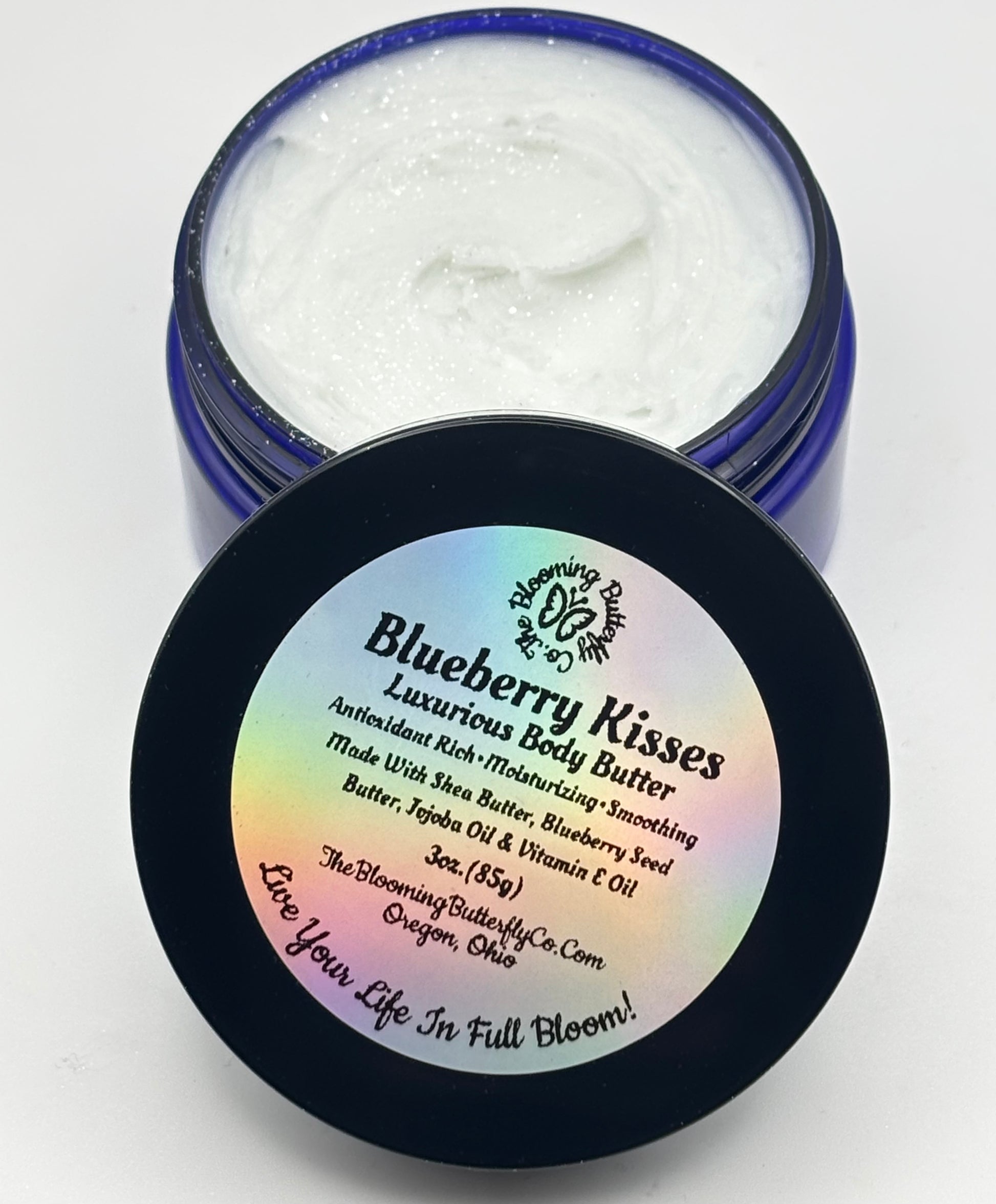 3 ounces of blueberry kisses, luxury body butter in a blue cobalt pet jar with a holographic label and a white background handcrafted by the blooming butterfly company