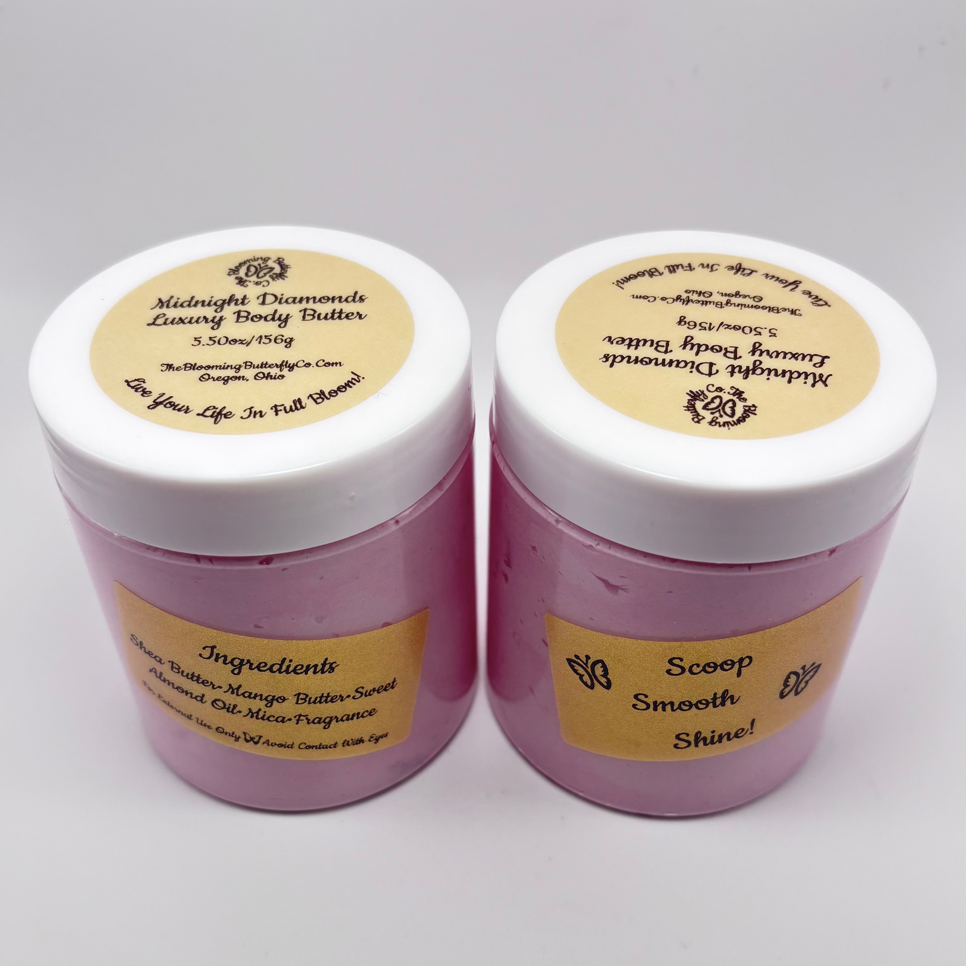 Two jars of midnight diamonds luxury body butter with gold, holographic labels and magenta colored Mica with white lids handcrafted by the blooming butterfly company