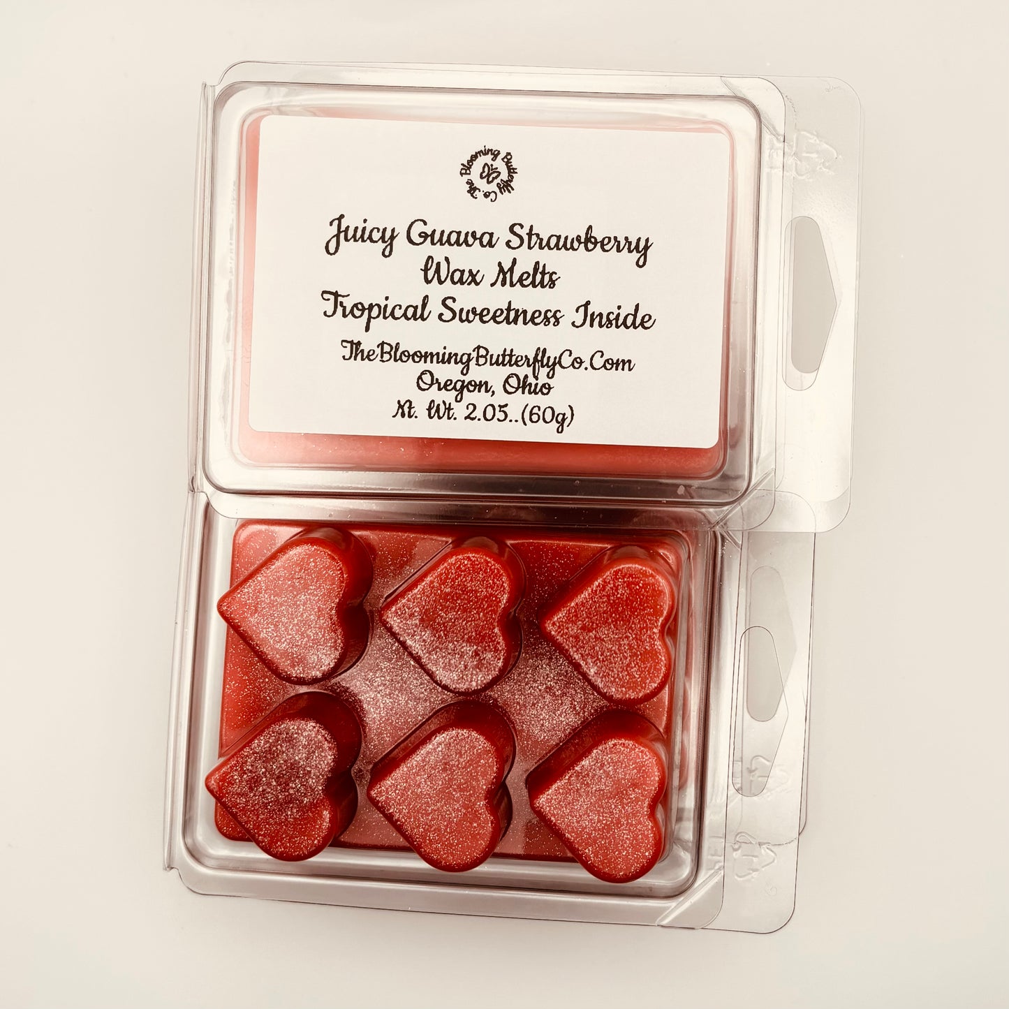 Juicy strawberry guava wax melts infused with shimmering, red and silver, glitter and heart shaped clam shells by the blooming butterfly company