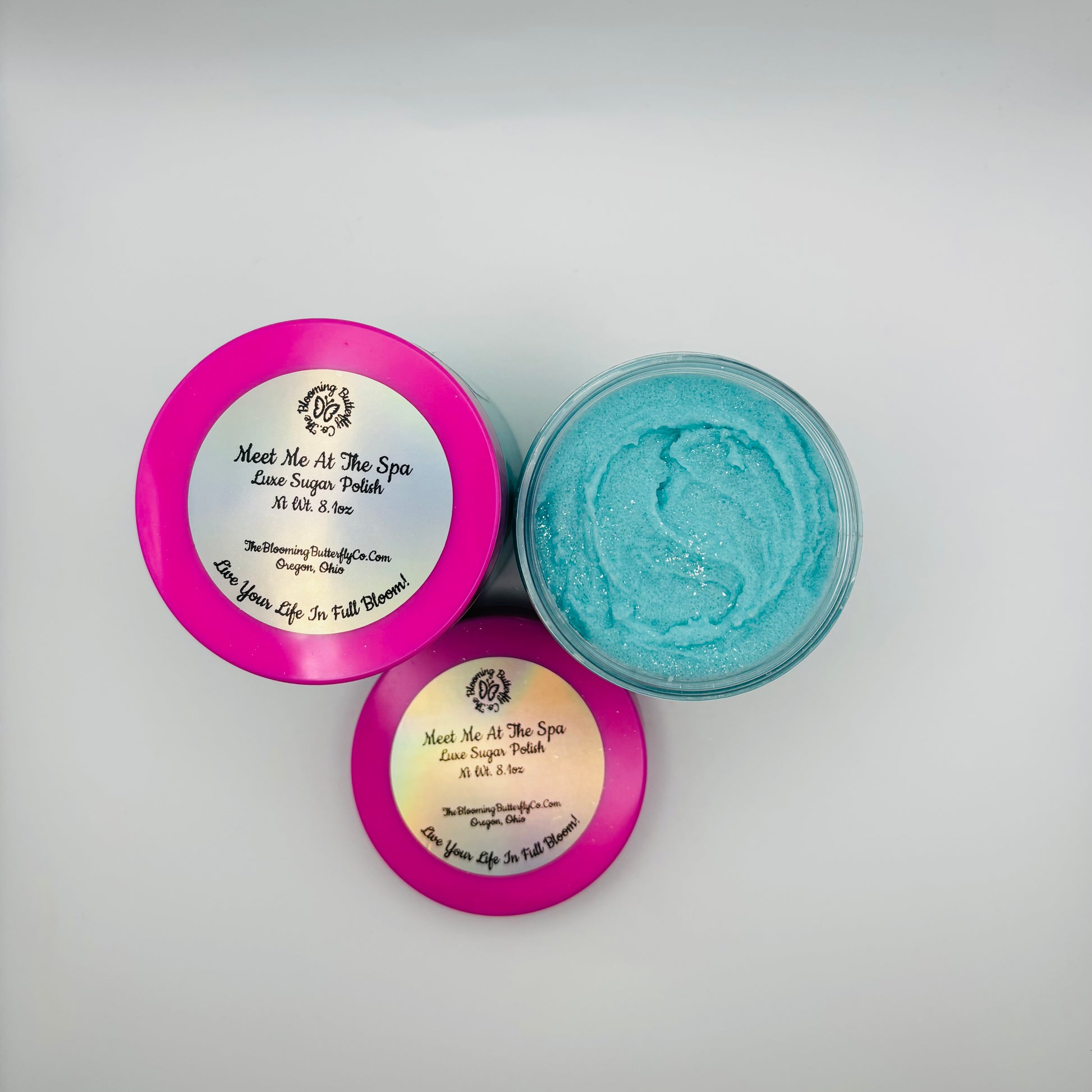 meet me at the spa sugar scrub in clear jar with barbie pink lid colored with sea glass mica and sparkles handcrafted by the blooming butterfly company