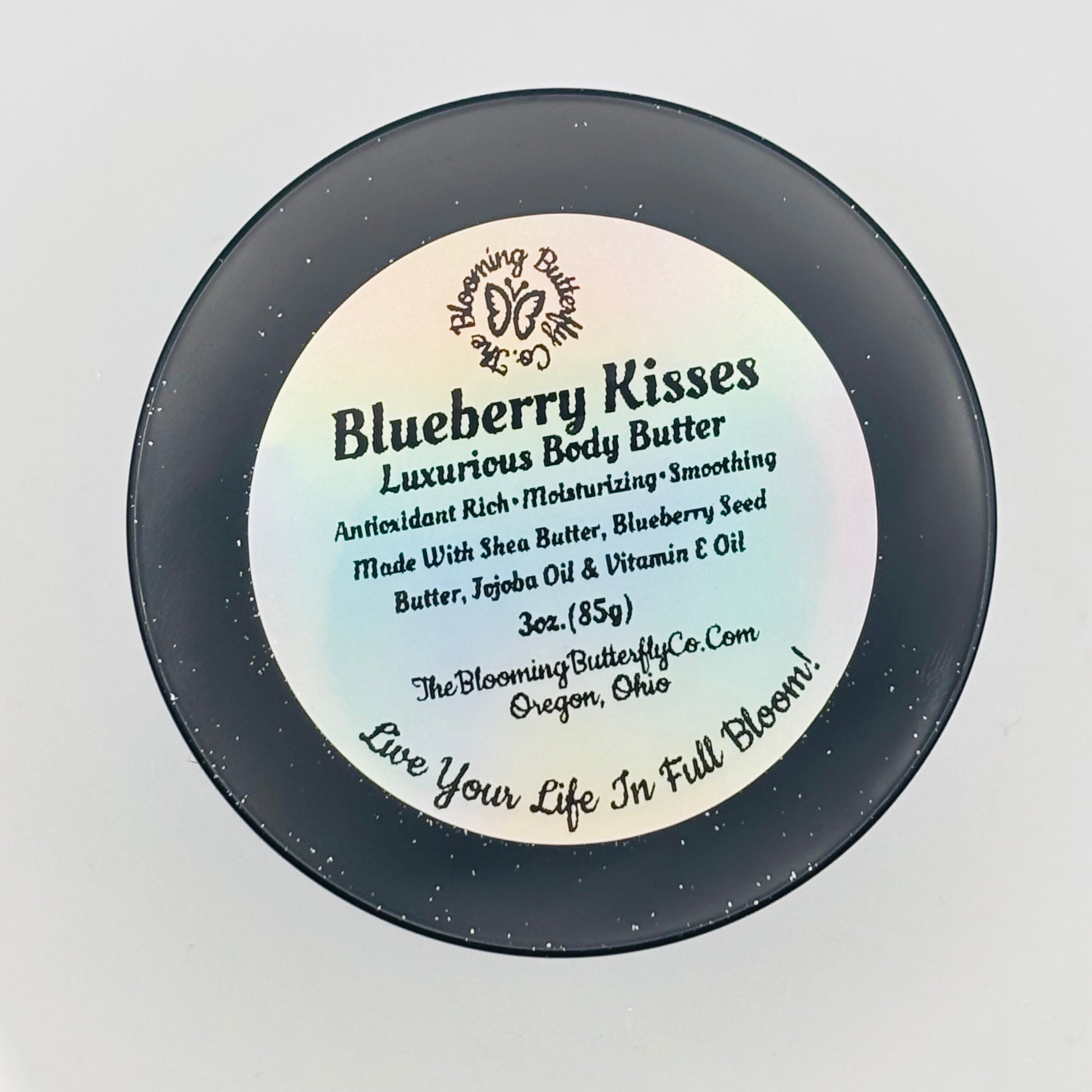 One jar of blueberry kisses luxurious body butter with holographic label on a white background handcrafted by the blooming butterfly company