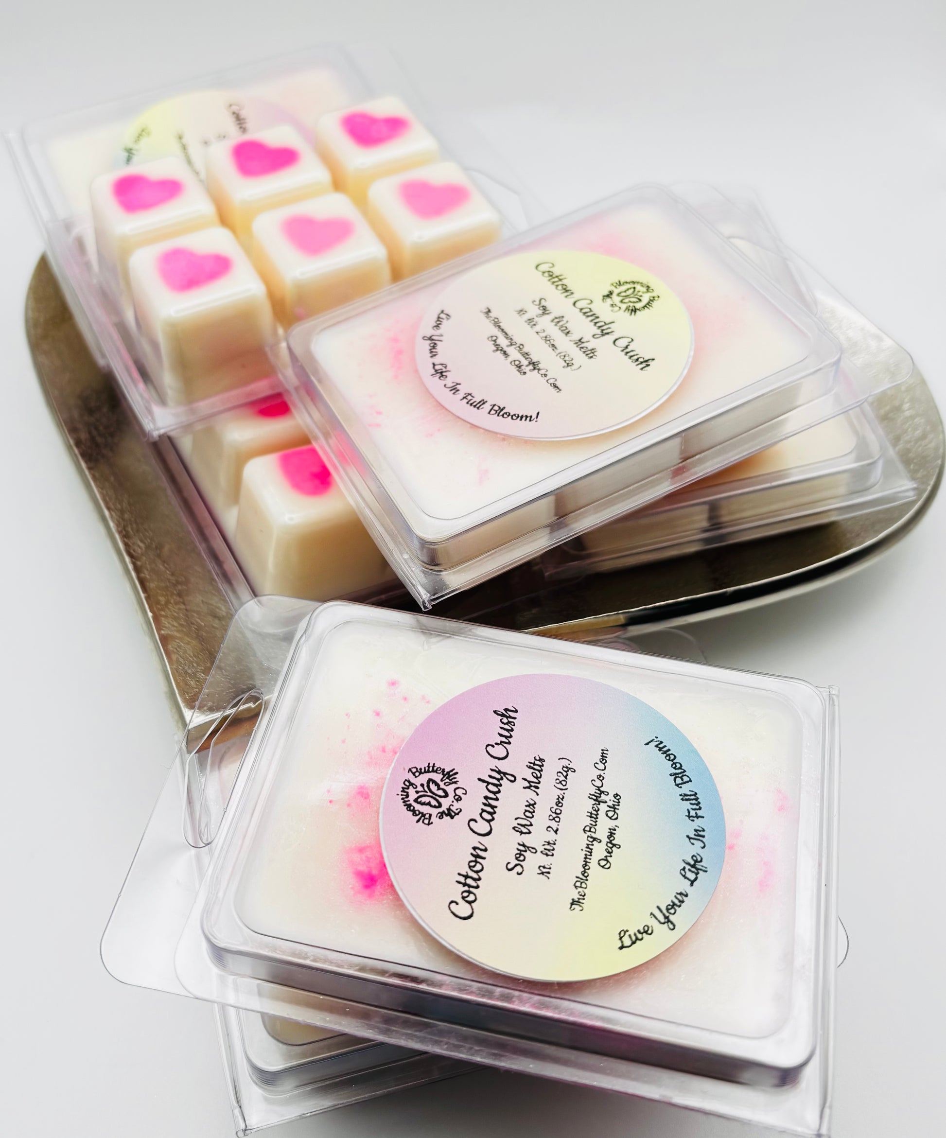 cotton candy wax melts in clam shell container with bright pink heart in the middle of shimmering white wax with sparkles by the blooming butterfly company