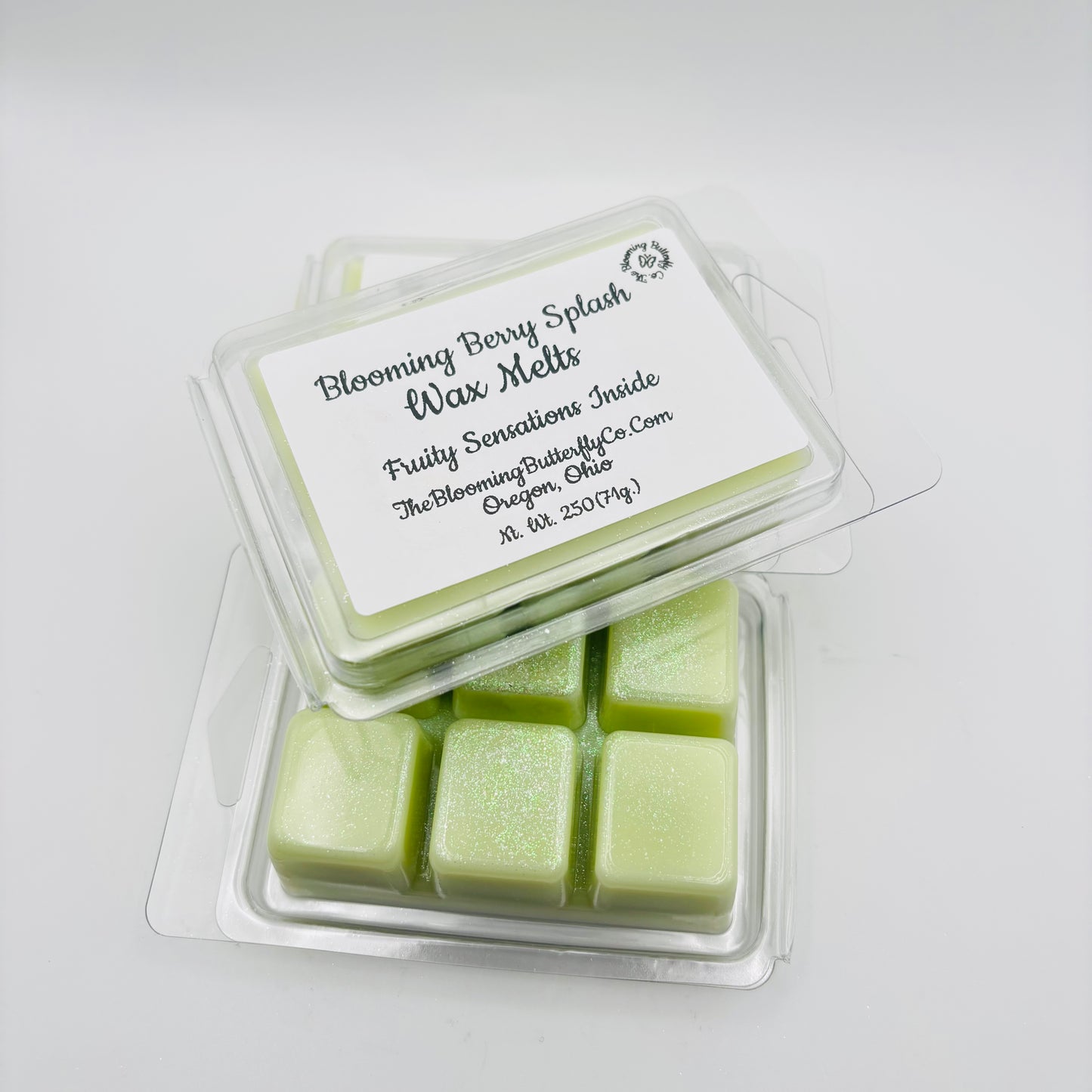 Pack of Blooming Berry Splash wax melts with a white label on a light gray background handcrafted by the blooming butterfly Company