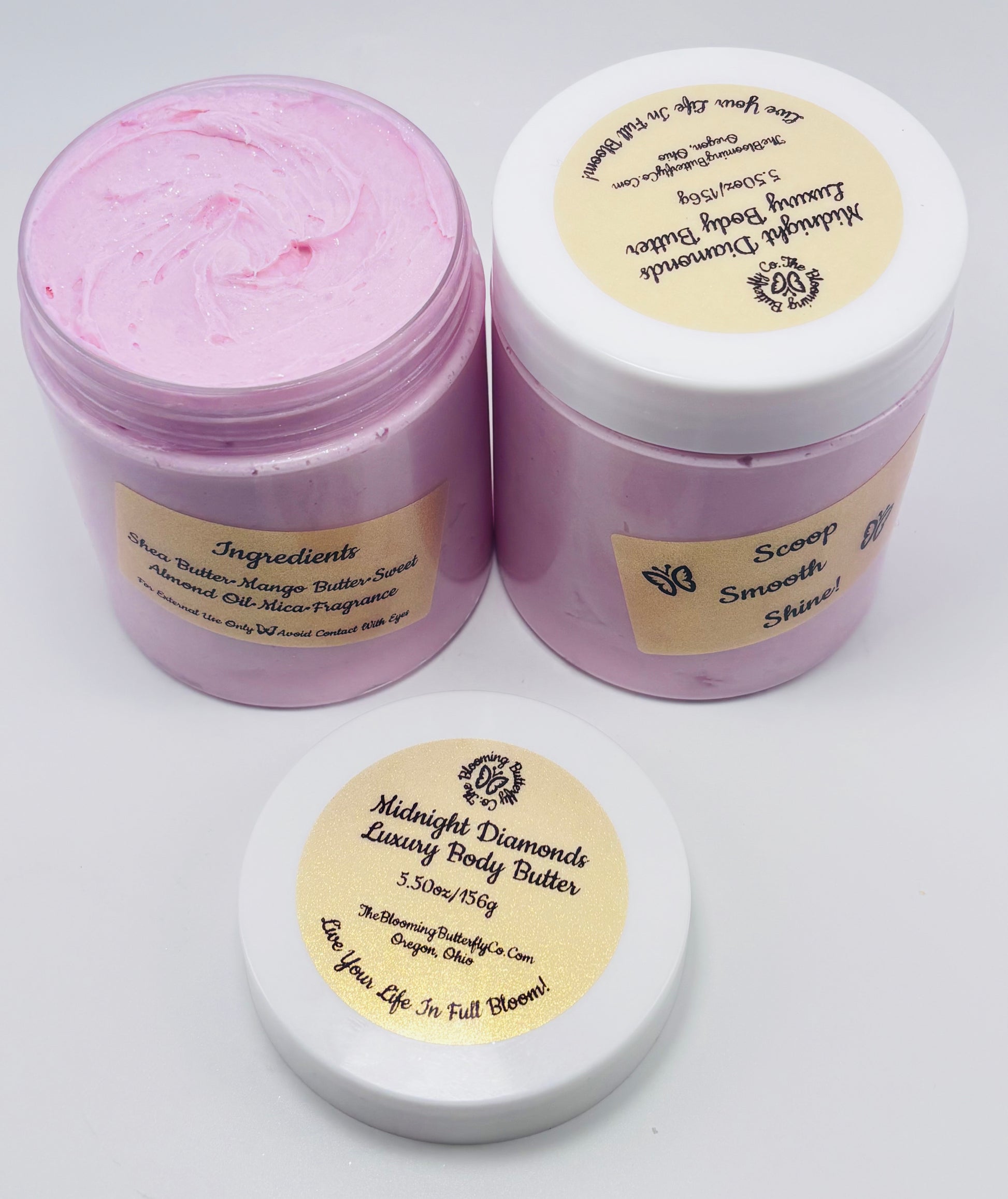 Two containers of Midnight Diamonds Luxury Body Butter with gold holographic labels on a white background handcrafted by the blooming butterfly company