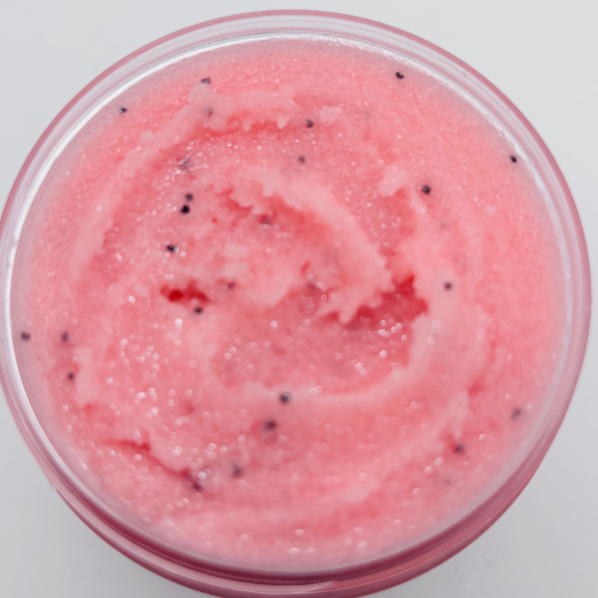 Pink Watermelon Glow Sugar Scrub with poppyseeds in a clear jar handcrafted by the blooming butterfly company