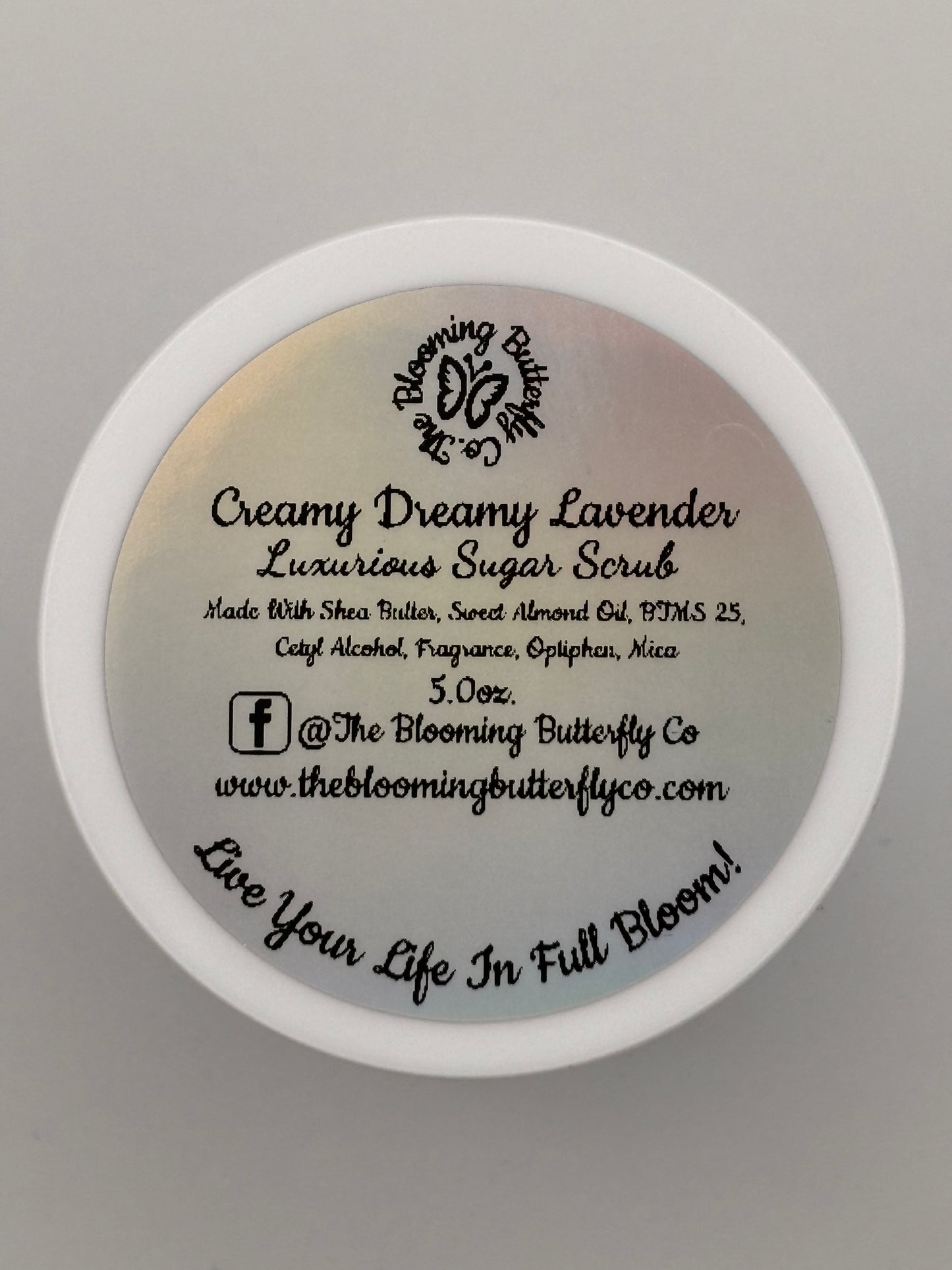 top view of a jar of Creamy lavender sugar scrub describing contents by the blooming butterfly company