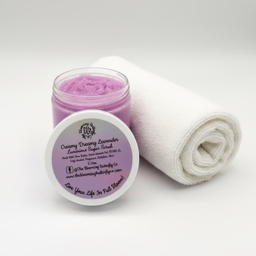 5oz. of creamy lavender sugar scrub infused with lavender colored mica with open lid to show texture by the blooming butterfly company