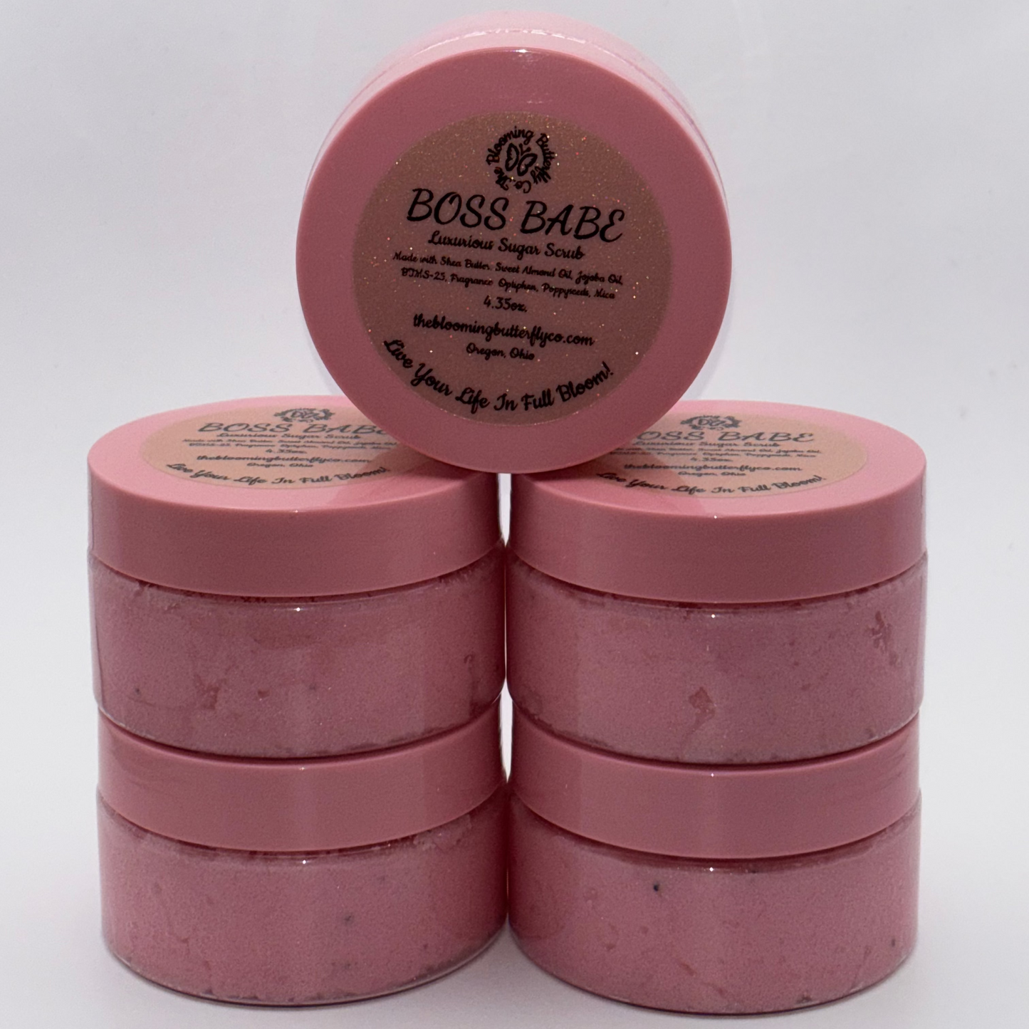 boss babe cotton candy and birthday cake sugar scrub with shimmering pink and poppyseeds in container with pink lid by the blooming butterfly company