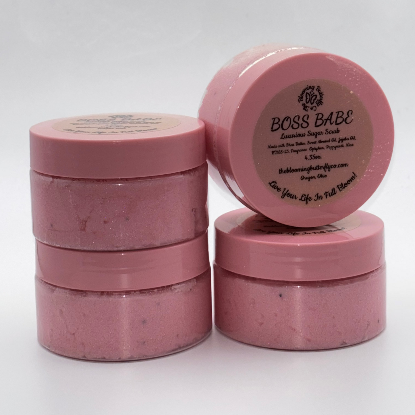 boss babe cotton candy and birthday cake sugar scrub with shimmering pink and poppyseeds in container with pink lid by the blooming butterfly company