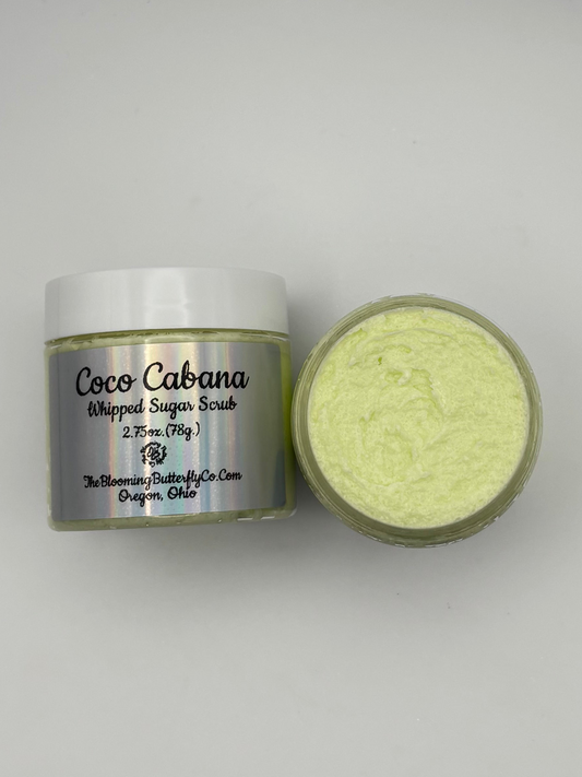 Two jars of cocoa  cabana whipped sugar scrub with a pastel green shimmering Micah and a silver holographic label handcrafted by the blooming butterfly company