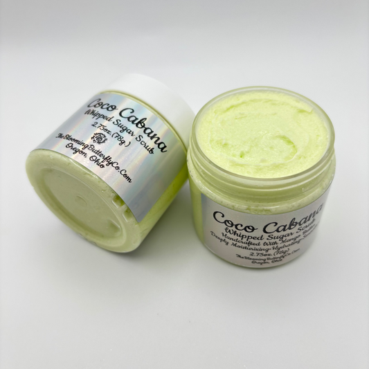 Two jars of Coco Cabana whipped sugar scrub with silver holographic labels made by the blooming butterfly company
