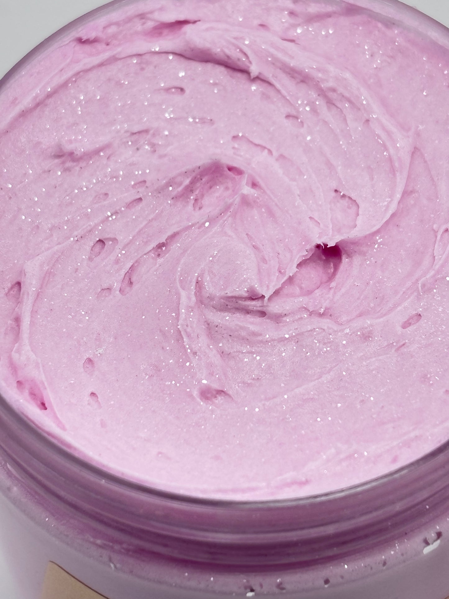 Close up of a jar of Midnight diamonds luxury body butter colored in a magenta mica with shimmering sparkles on top handcrafted by the blooming butterfly company