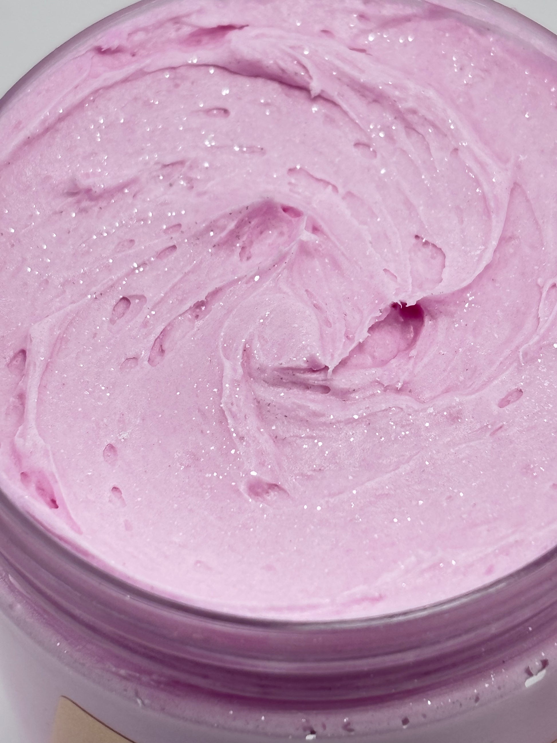Close up of a jar of Midnight diamonds luxury body butter colored in a magenta mica with shimmering sparkles on top handcrafted by the blooming butterfly company