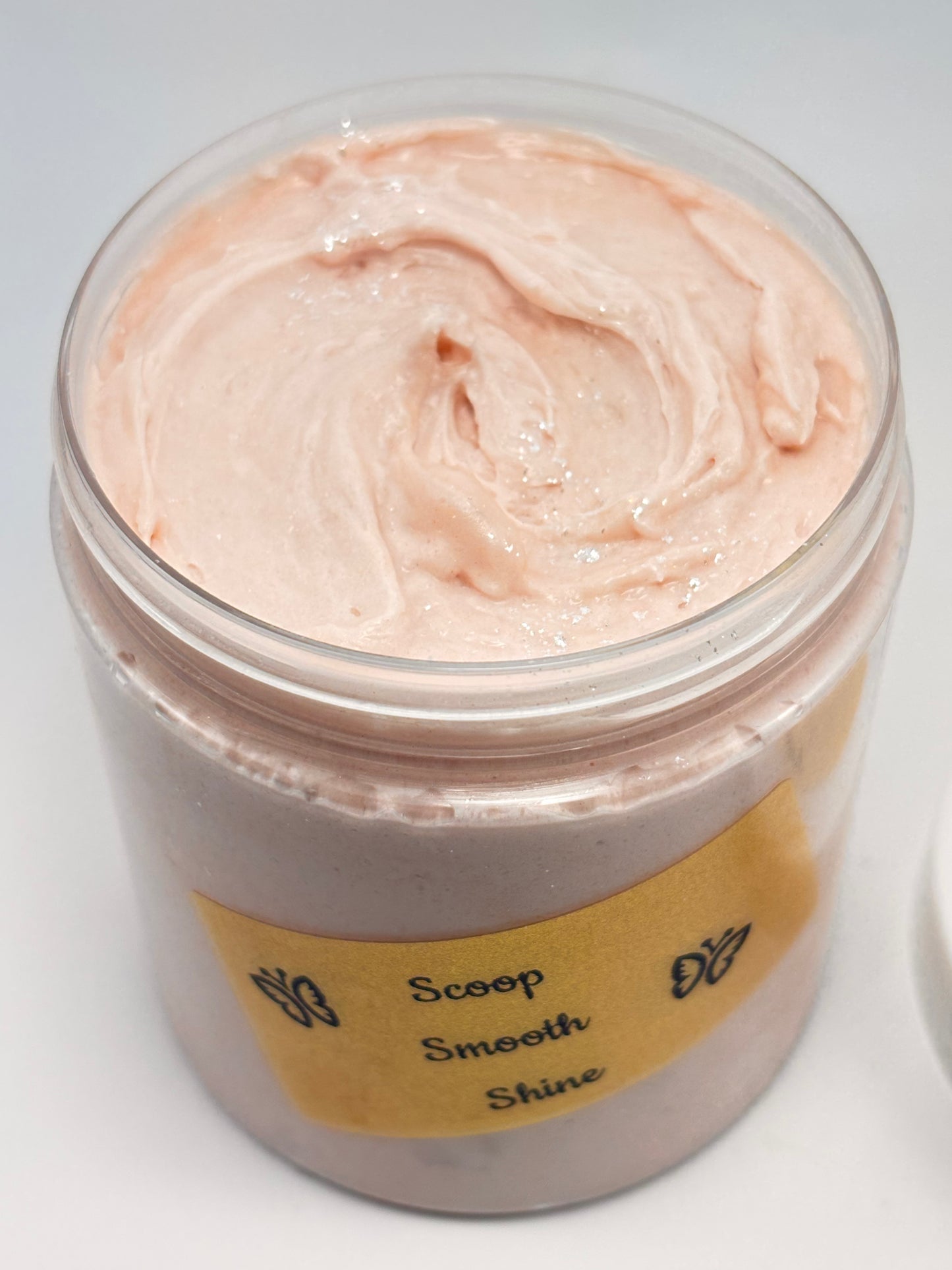 Jar of Cashmere Vanilla Cream luxury body butter with white lid and gold holographic label with shimmering sparkles on top handcrafted by the blooming butterfly Company