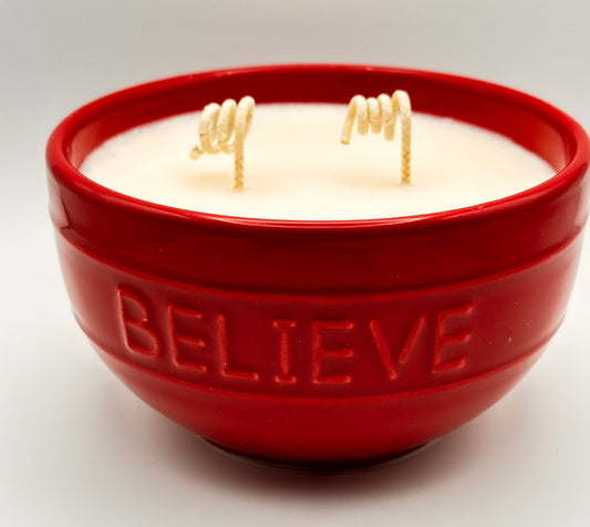 christmas candle with sparkles in decorative red bowl