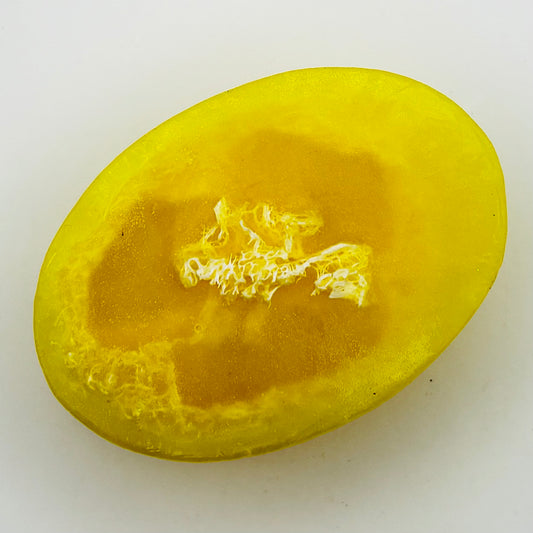 close up top view of bright yellow  citrus agave loofah soap bar by the blooming butterfly company