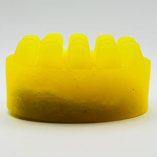 close up photo of bright yellow citrus agave loofah massage soap bar by the blooming butterfly company 