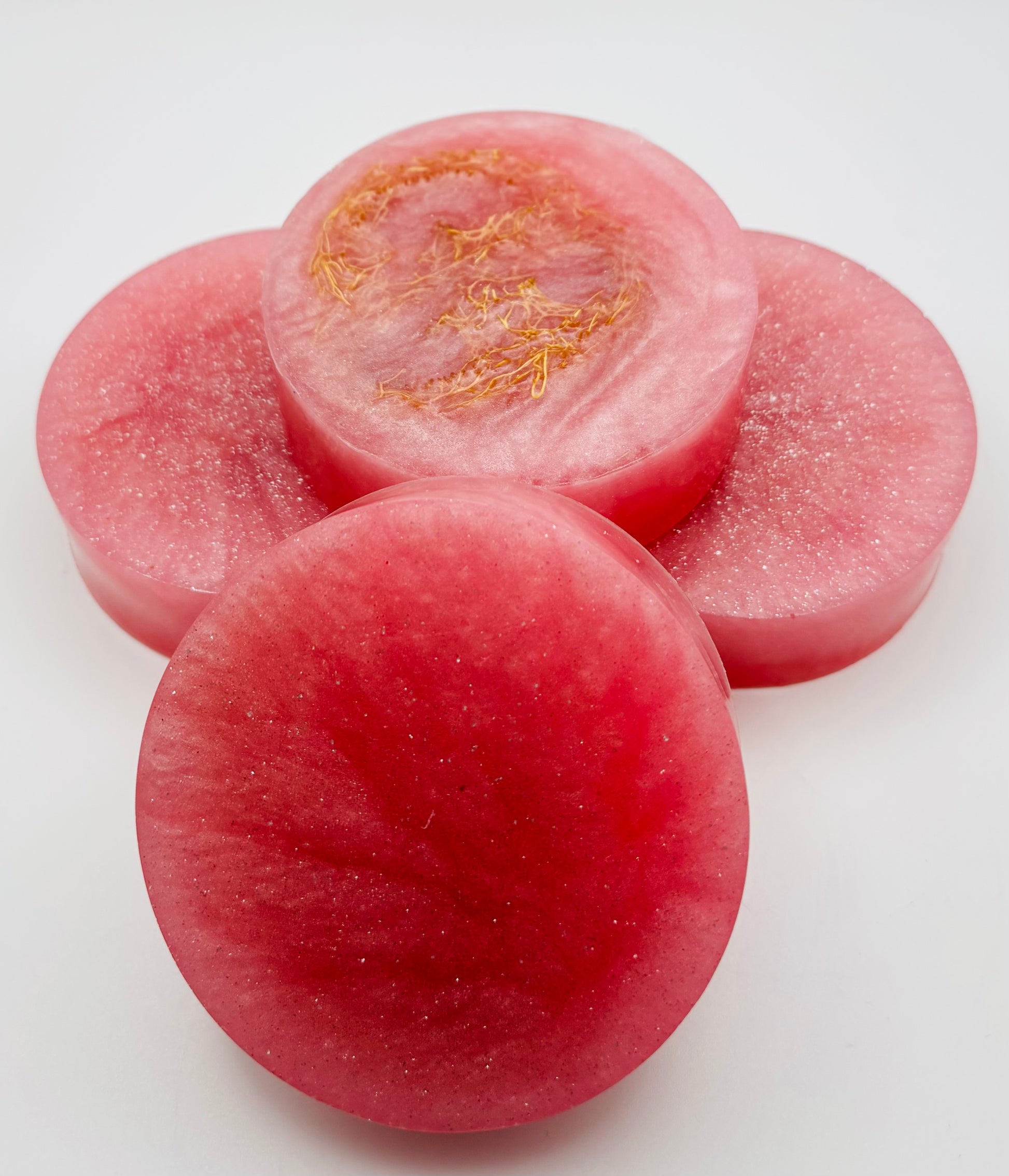 close up of pink sparkling grapefruit loofah soap bars showing the organically grown loofah and pink mica by the blooming butterfly company