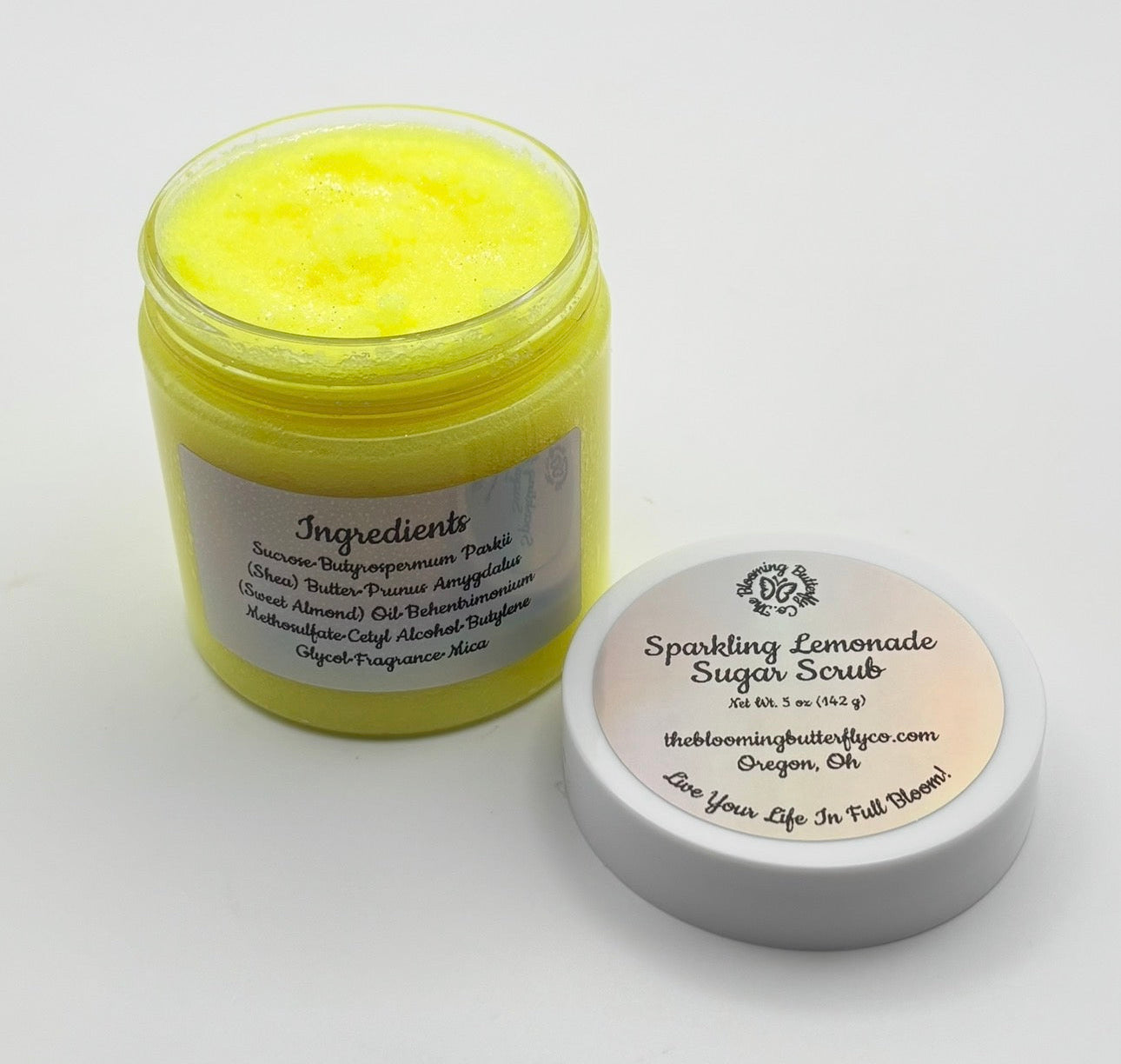 5oz. of sparkling lemonade sugar scrub colored in bright yellow mica infused with shea butter, with a creamy texture by blooming butterfly company