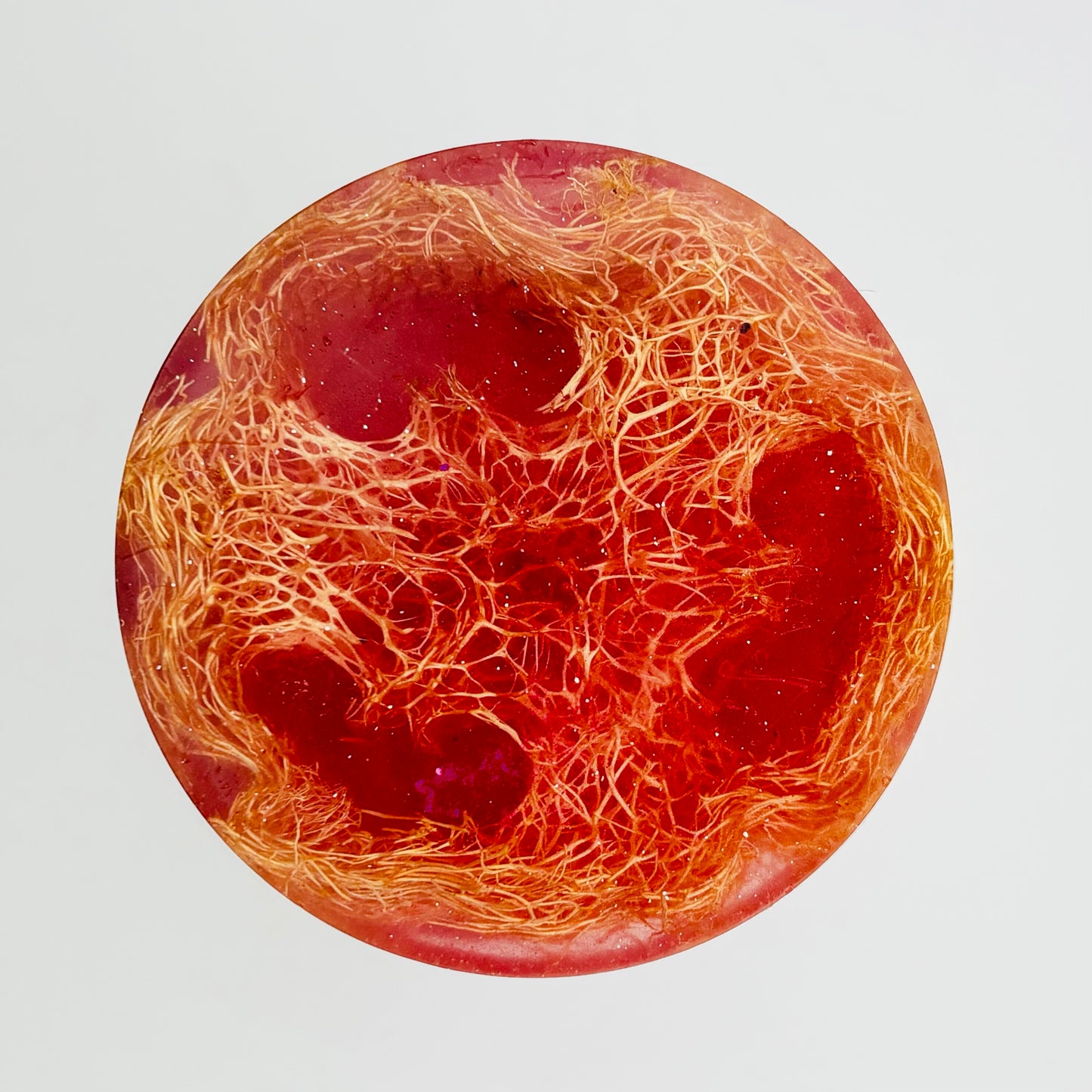 A thousand wishes scented loofah soap bar pictured up close infused with shimmering magenta colored mica and organically grown loofah by the blooming butterfly company