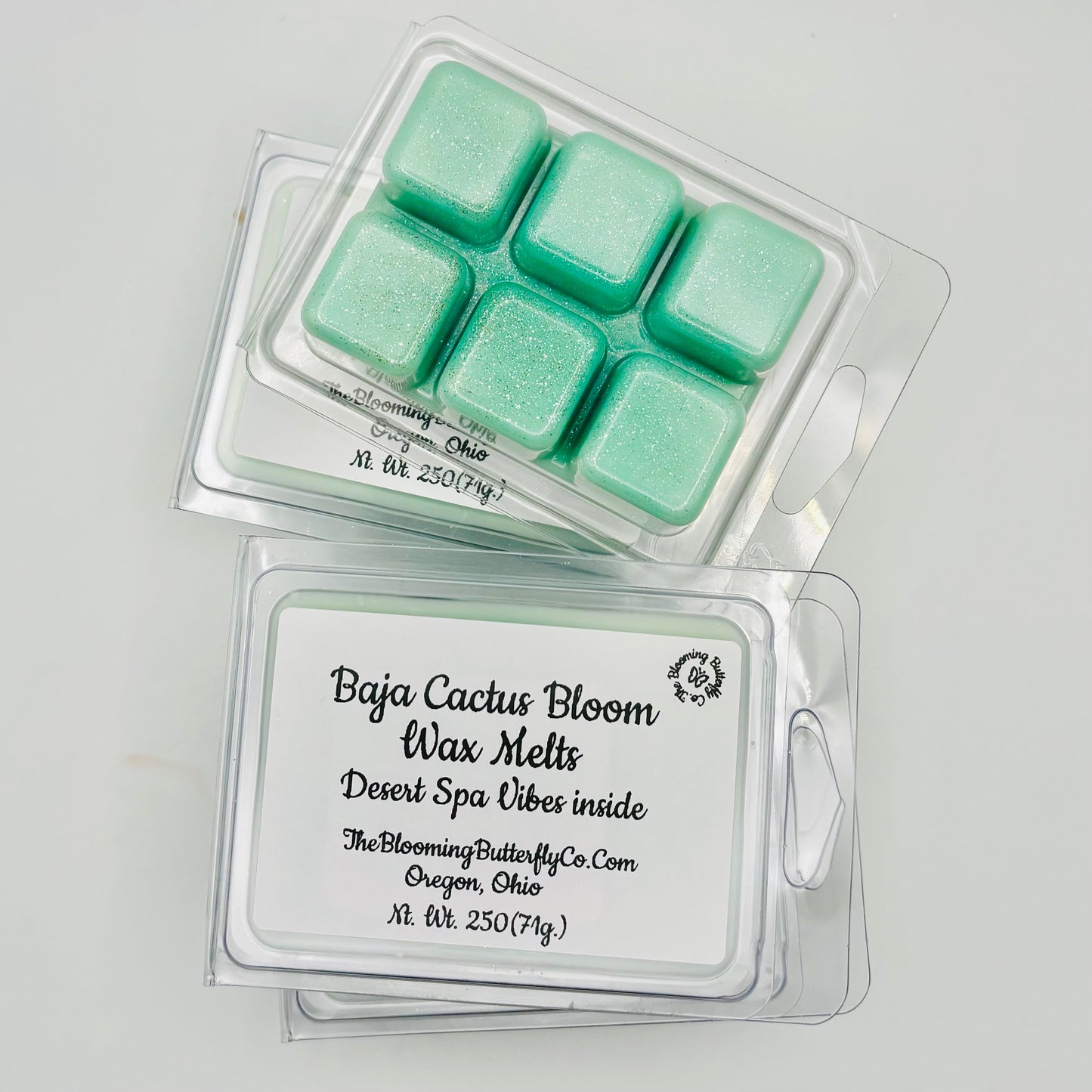 6 pack clamshells of baja cactus bloom wax melts with shimmering green sparkle and a label made by the blooming butterfly company