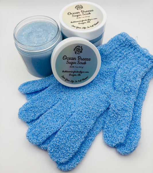 Two blue jars of Ocean Breeze Sugar Scrub with gloves and holographic labels handcrafted by the blooming butterfly company
