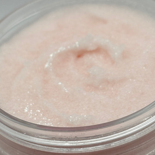 Close-up of a pink Marshmallow Magic Sugar Scrub in a clear container with a white background Handcrafted by the blooming butterfly company