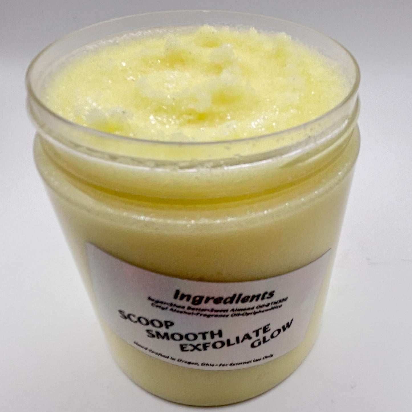 jar of island tropics citrus sugar scrub with holographic label handcrafted by the blooming butterfly company